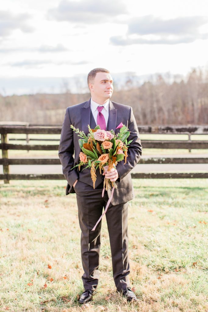 Groom holding boho bridal bouquet at Mount Ida Farm in Charlottesville Virginia