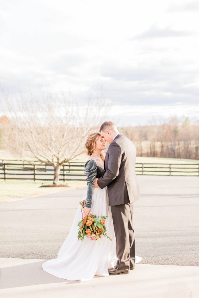 Bride and groom kissing in field at Mount Ida Farm in Charlottesville Virginia