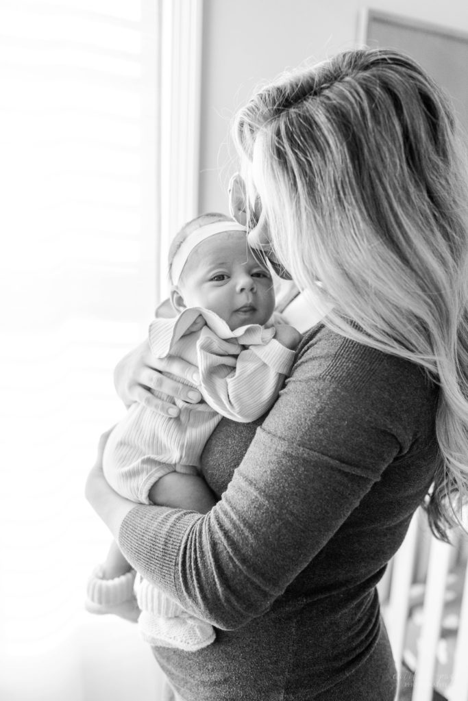 Black and white portrait of baby being held by mom