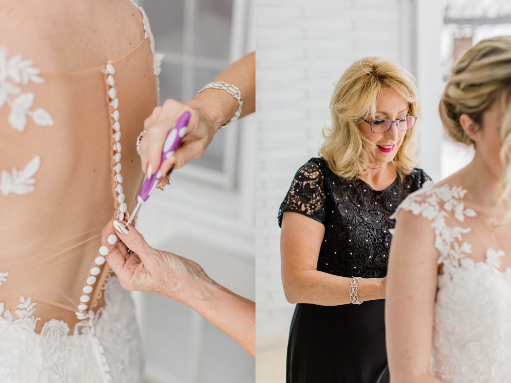 Bride getting her dress buttoned up by her mom
