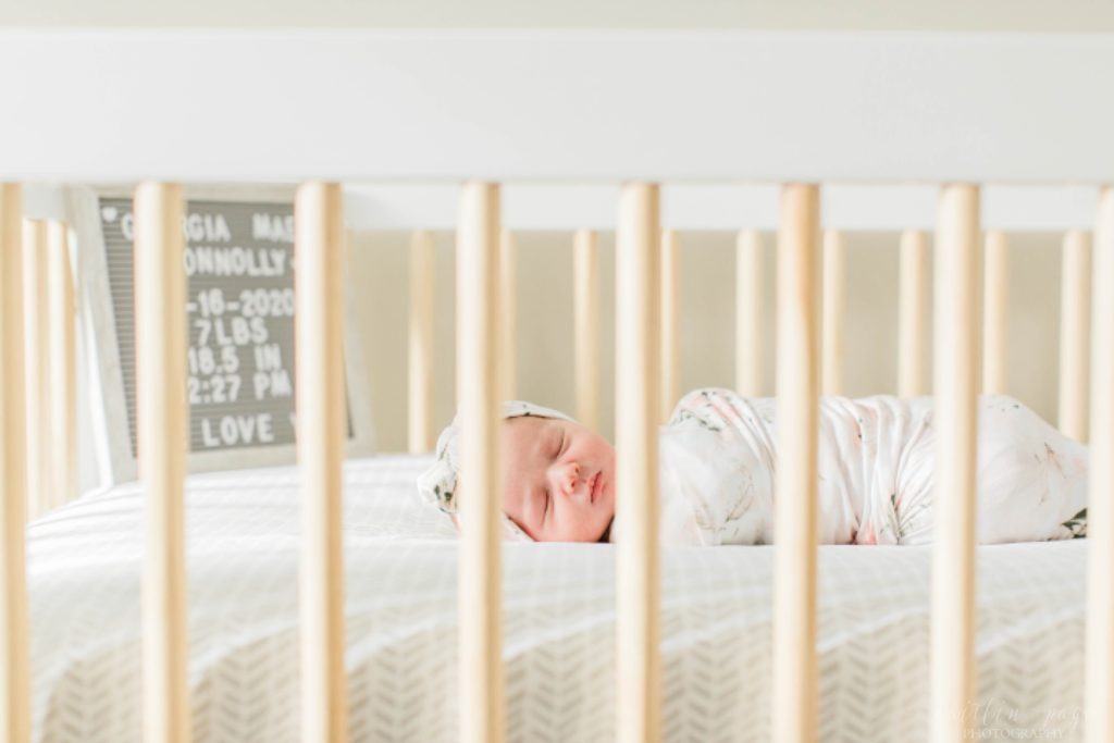 Newborn baby girl in crib