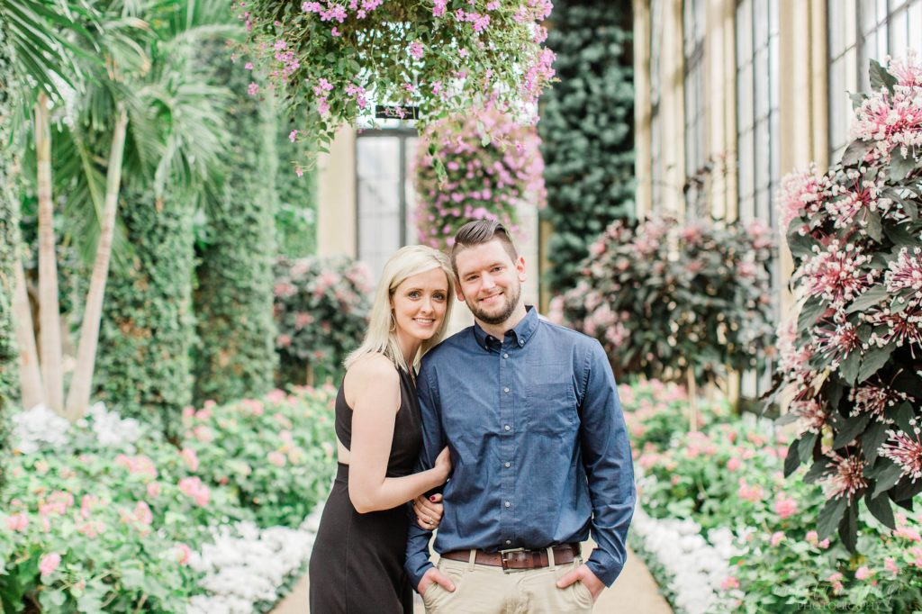 Man and woman smiling together under floral display at Longwood Gardens