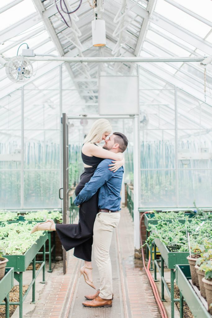 Man lifting woman in greenhouse at Longwood Gardens