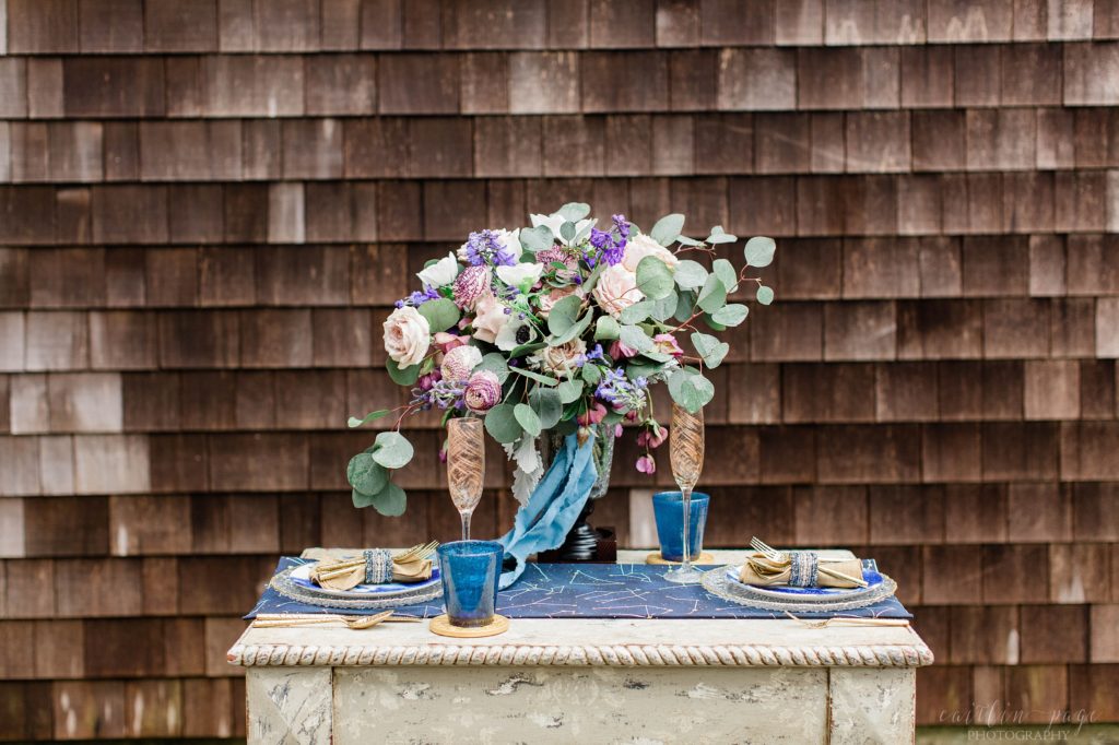 Styled elopement wedding reception table details with blue and gold accents