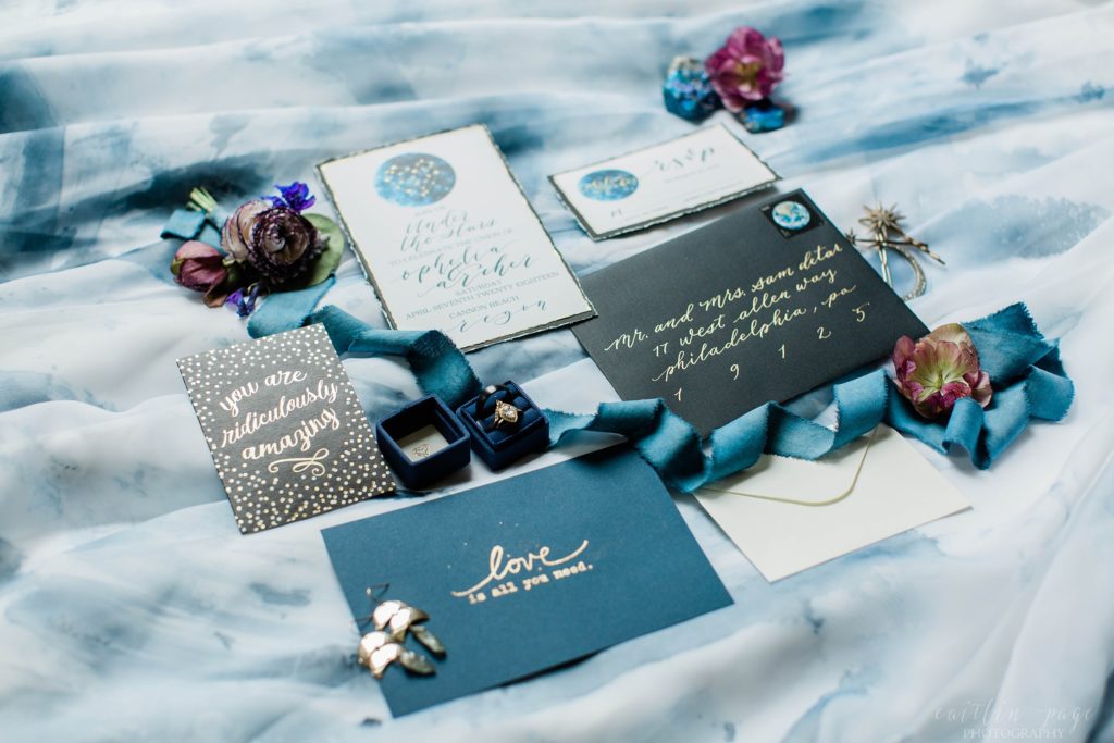 Styled elopement invitation suite with blue accents