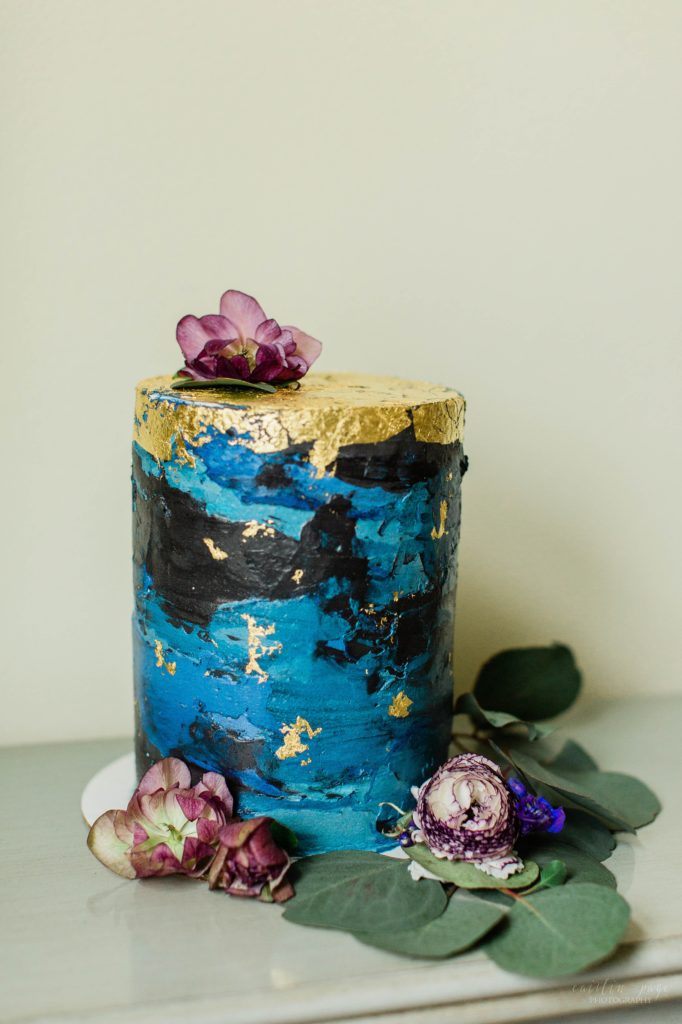 Styled elopement wedding cake with blue and gold foil accents