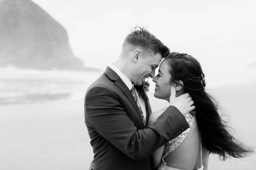 Black and white portrait of bride and groom laughing at each other