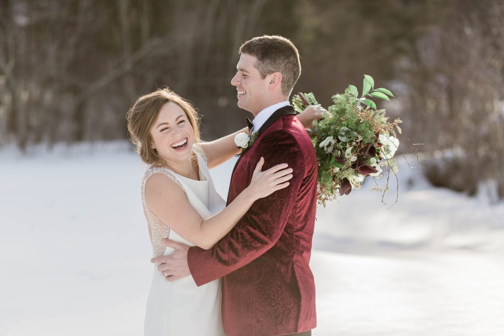 Wedding couple standing together on frozen Lake Winnipesaukee in Wolfeboro New Hampshire