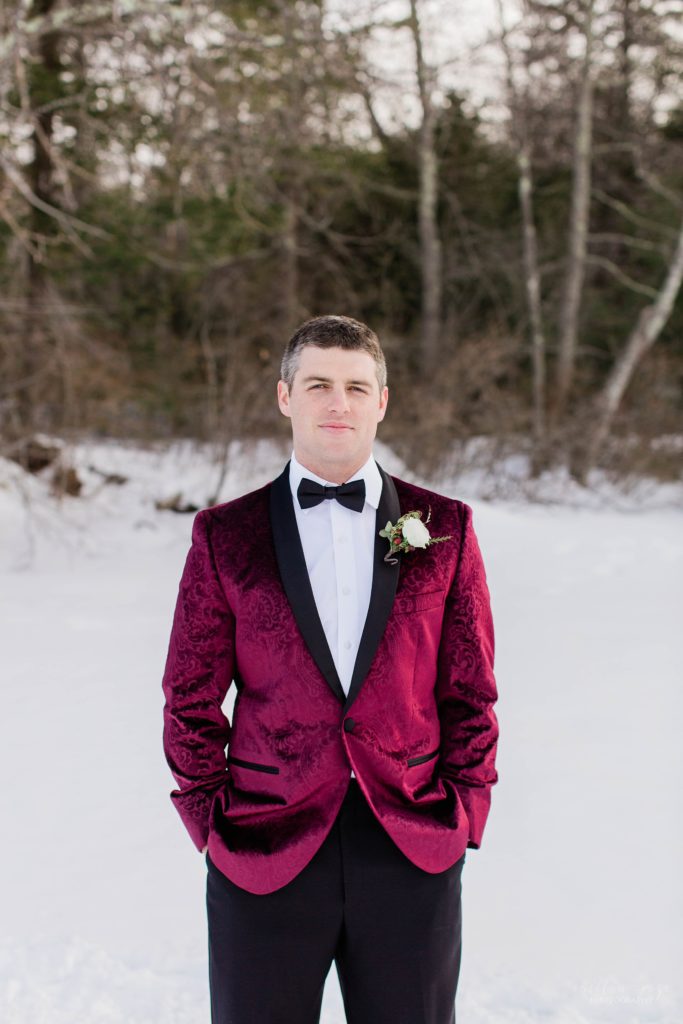Groom in burgundy tuxedo jacket