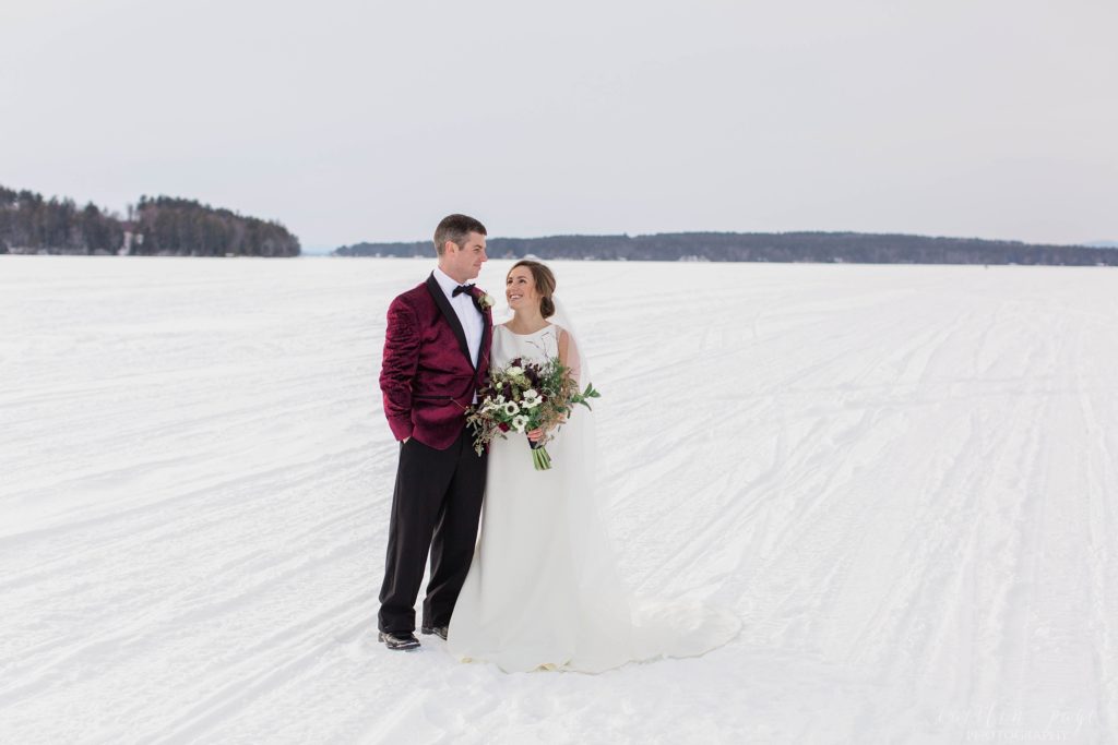 Bride and groom standing in the middle of a frozen lake