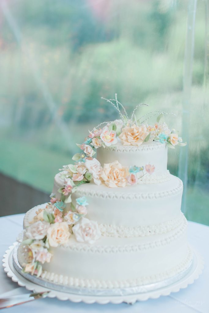 White wedding cake with delicate sugar spun floral decorations