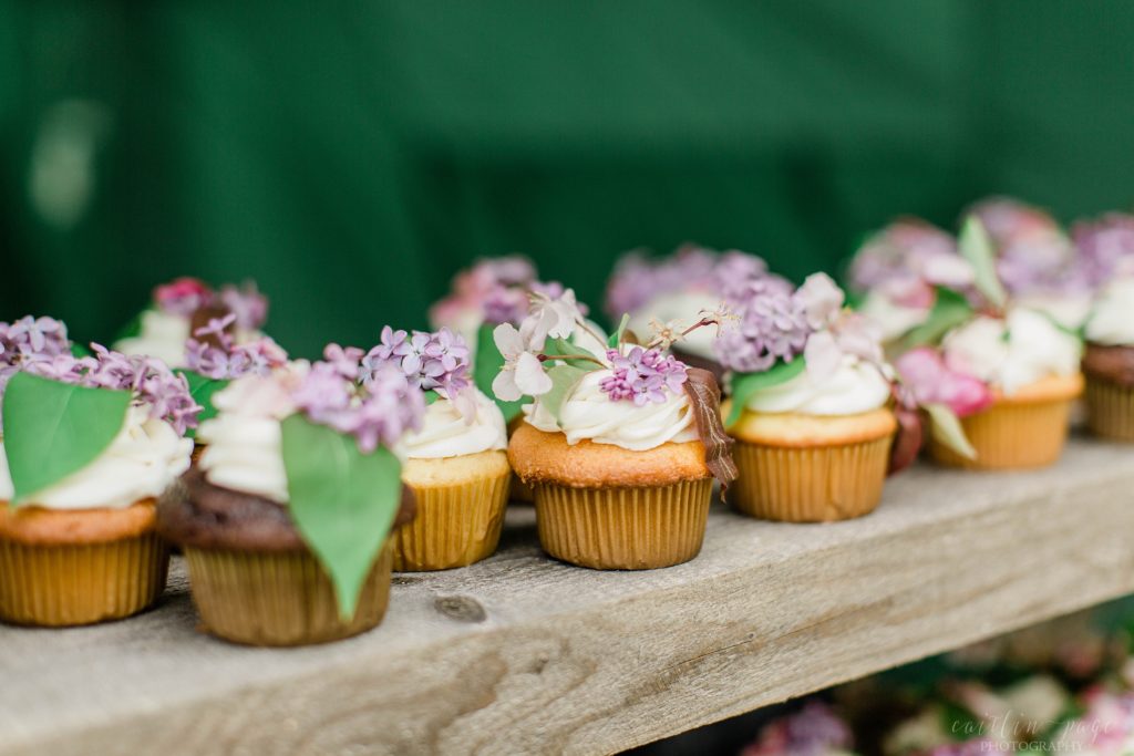 Vanilla and chocolate cupcakes with fresh lilacs on them