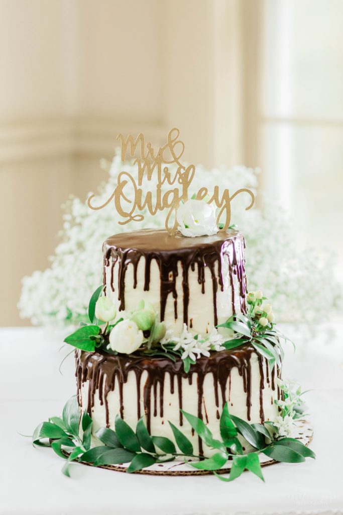 White wedding cake with chocolate ganache dripped all over it