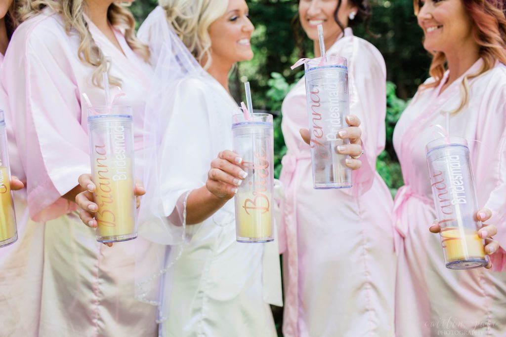 Bride and bridesmaids in matching robes with personalized cups