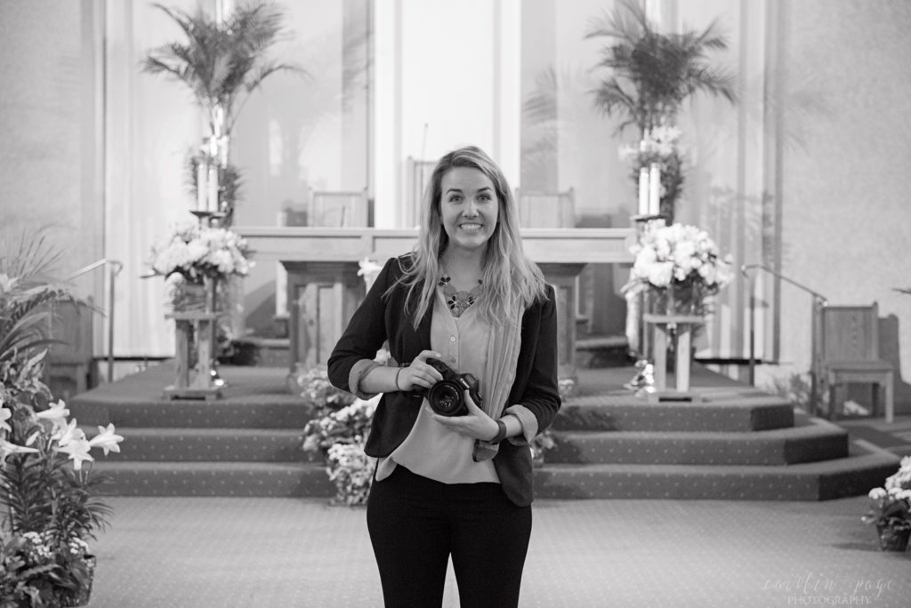 Woman standing in church holding camera