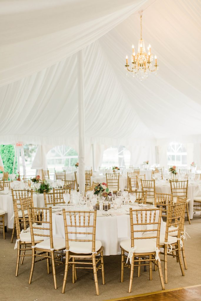 White sailcloth tent with wedding reception set up inside