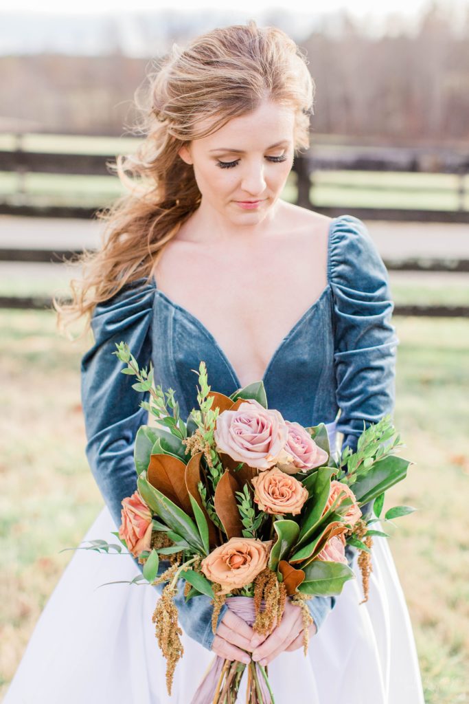 Bride holding textured bouquet with wheat chaff and roses