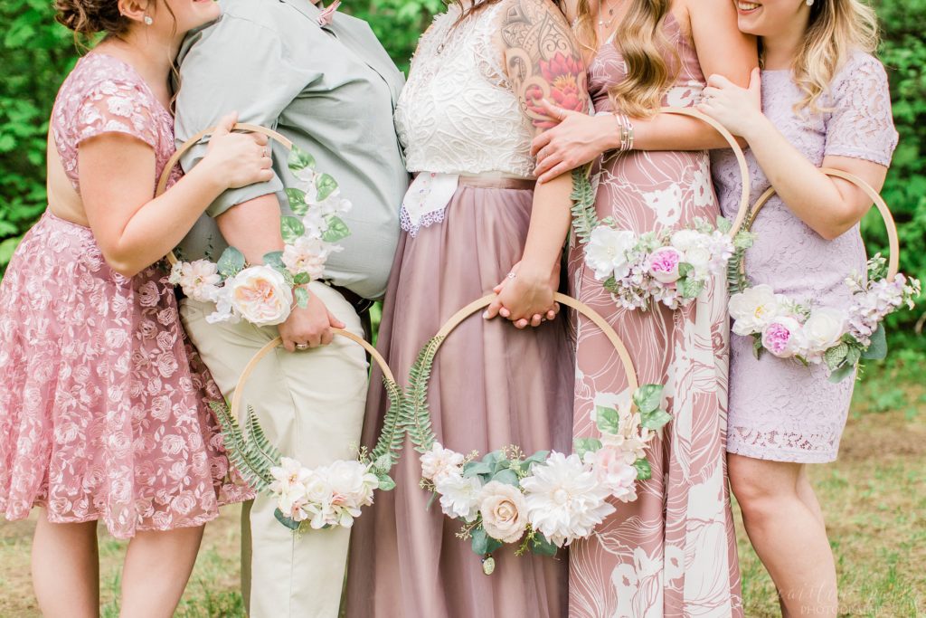 Bride and bridesmaids holding flower hoops