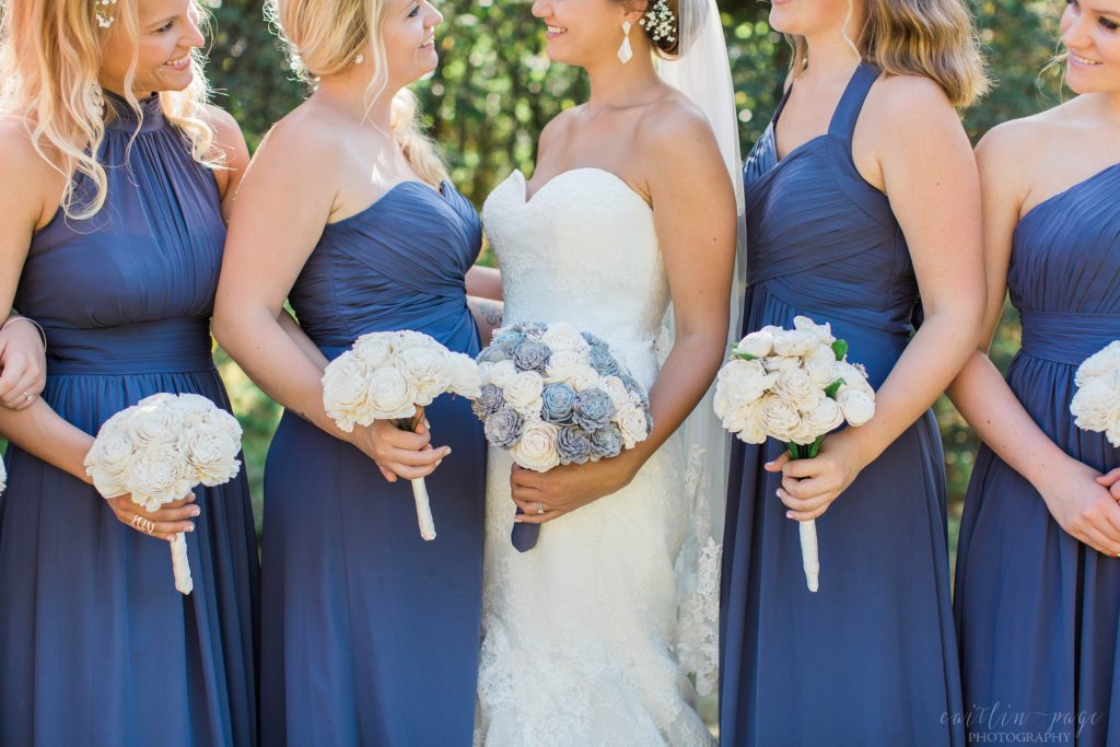 Bride and bridesmaids holding Sola wood flower bouquets