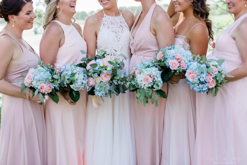 Bride and bridesmaids holding classic hydrangea and rose bouquets