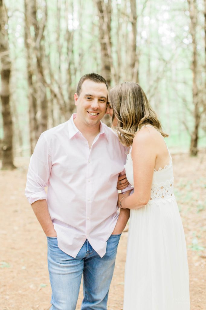 Woman nuzzling man in the woods