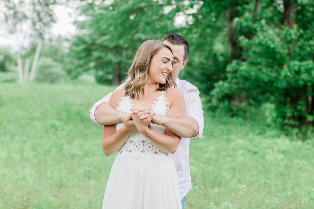 Man holding woman in a field