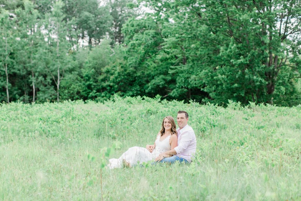 Man and woman sitting together in field