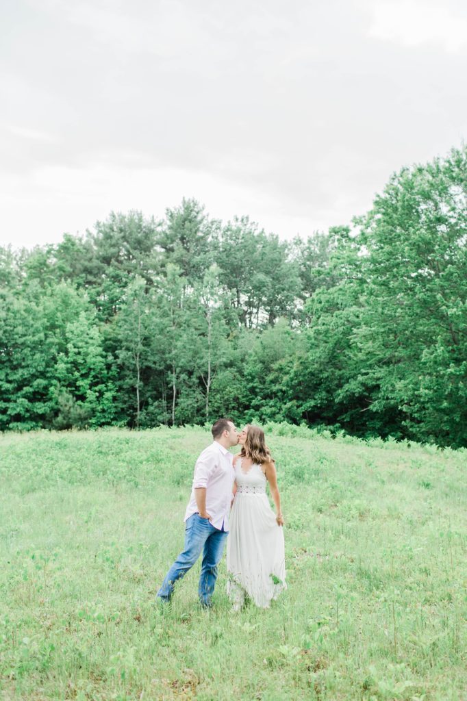 Man and woman kissing in field