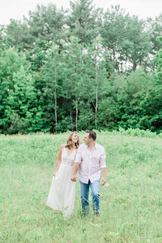 Man and woman walking and laughing in a field