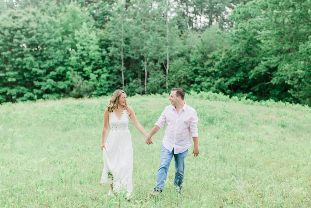 Man and woman walking and laughing in a field