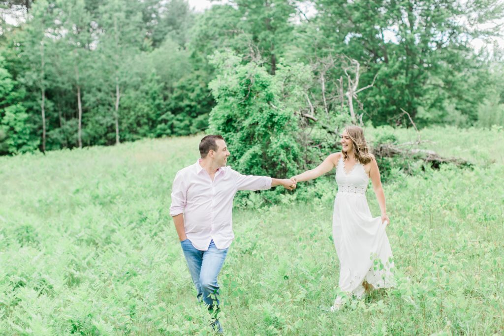 Man leading woman through a field