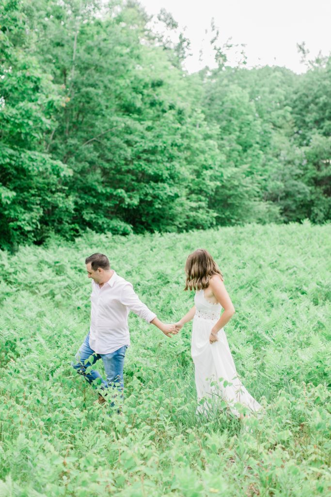 Man leading woman through a field