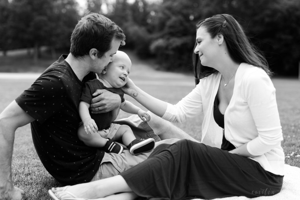 Black and white photo of mom and dad and baby boy