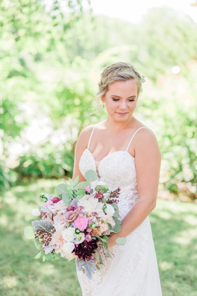 Outdoor summer bridal portrait with textured pink wedding bouquet