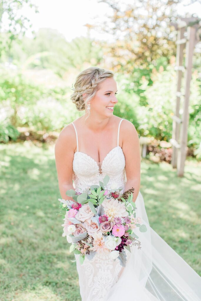 Outdoor summer bridal portrait with textured pink wedding bouquet