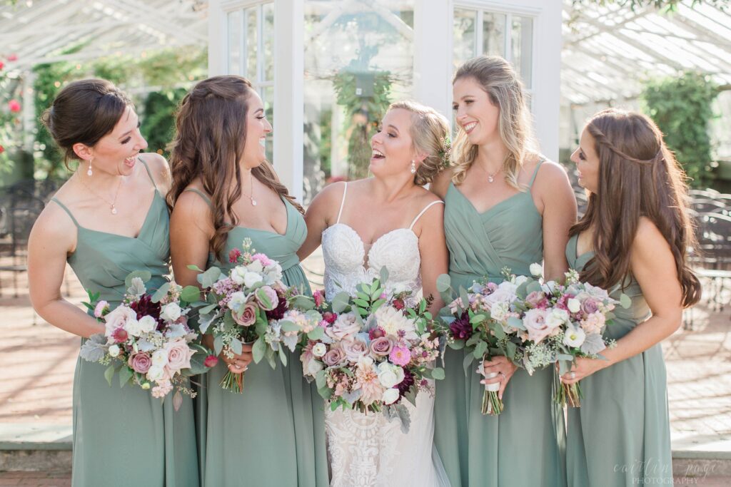 Bridesmaids standing outside greenhouse at Barn on the Pemi