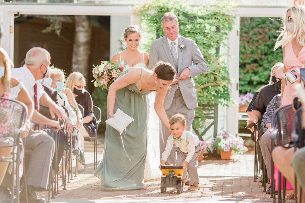 Bridesmaid rescuing ring bearer down the aisle