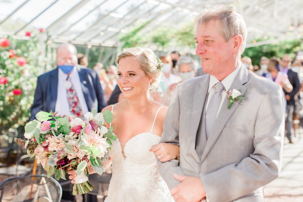 Bride and father walking down the aisle together at Barn at the Pemi