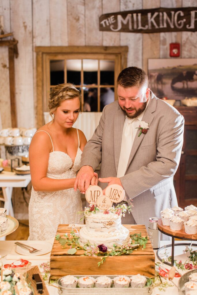 Bride and groom cutting cake at the Barn on the Pemi