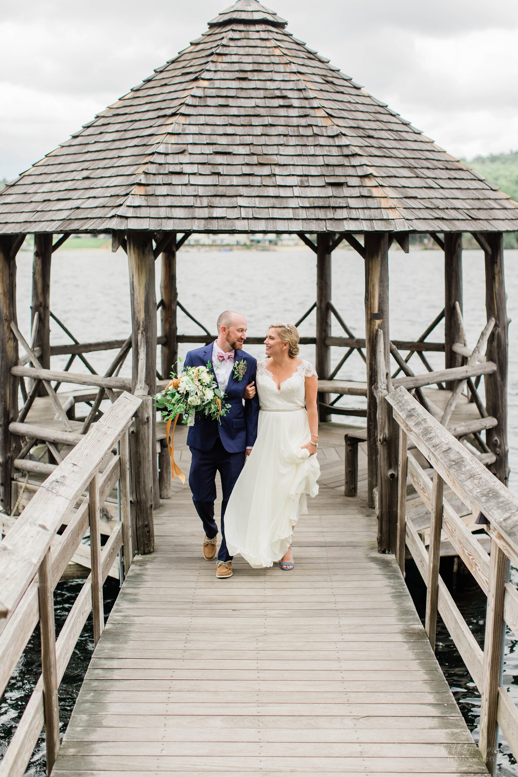 Portrait of bride and groom on town docks at Church Landing