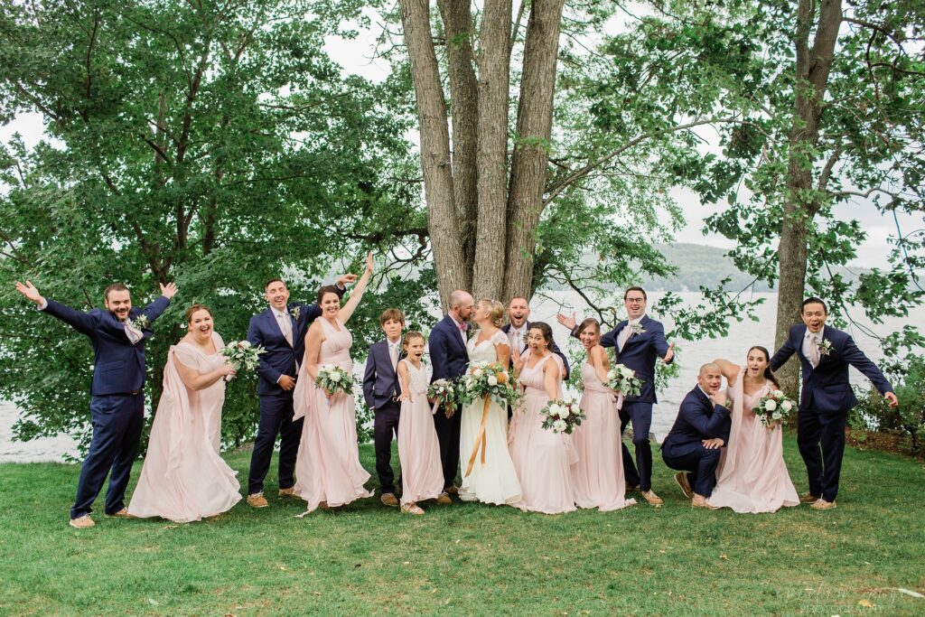 Bridal Party standing together in front of Lake Winnipesaukee at Church Landing