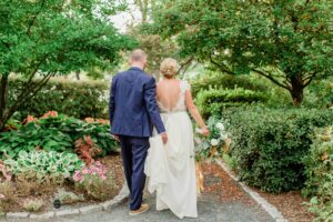 Bride and groom walking down garden path at Church Landing