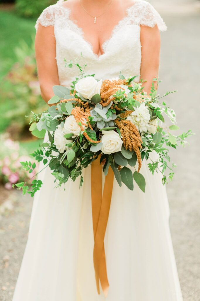 Brides wedding bouquet with textured greens, white and rust