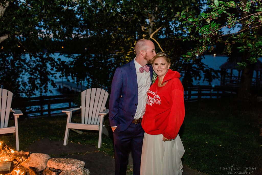 Bride and groom standing out at fire pit