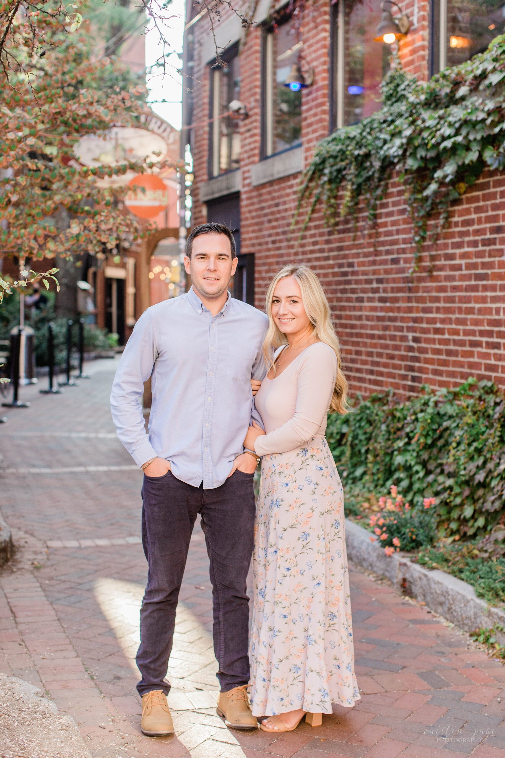 Couple standing in brick alley in Portsmouth