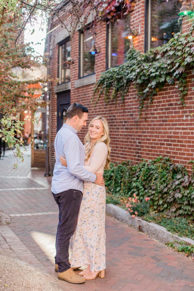 Couple standing in brick alley in Portsmouth