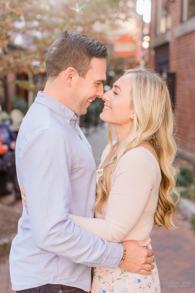 Couple standing in brick alley in Portsmouth