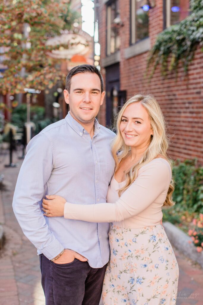 Couple standing in brick alley in Portsmouth