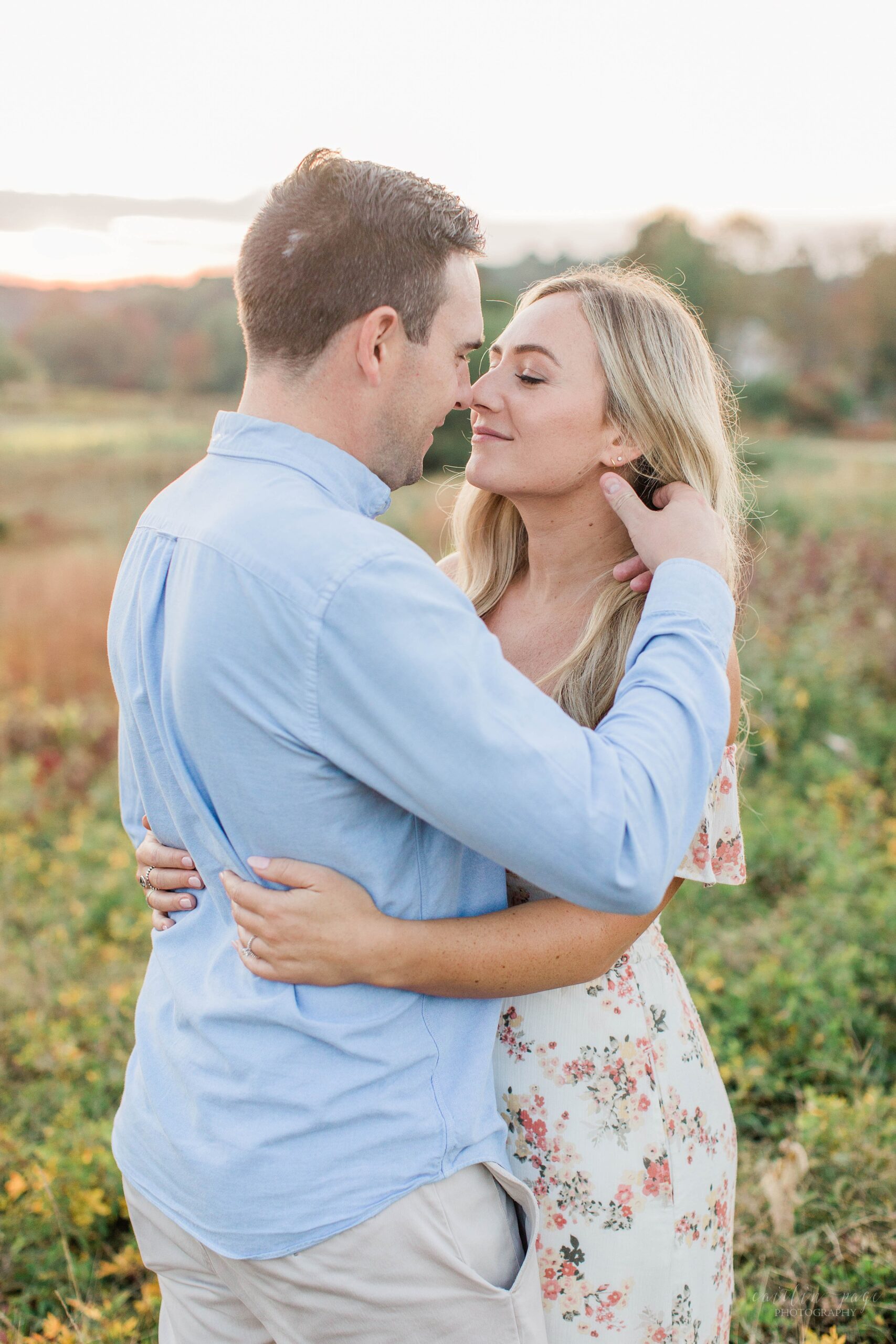 Man and woman standing in a field at sunset at Wagon Hill Farm