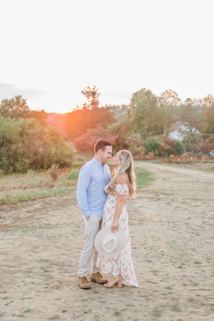 Man and woman kissing at sunset at Wagon Hill Farm